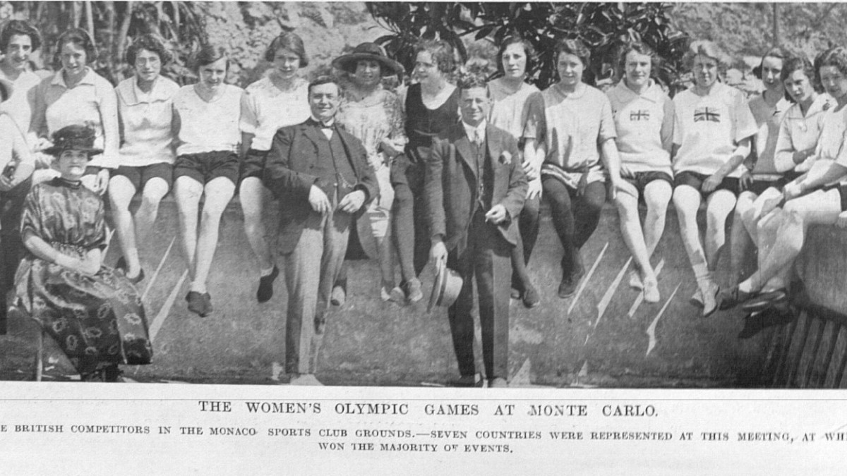 A photograph of some members of the British team at the 1922 Monte Carlo International Women's Games. They are wearing their athletics kit and sitting on a wall.