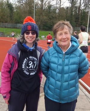 Katie Holmes and Hilary Walker IAU General Secretary at the Crawley 24 Hour Track Race. They are both warmly dressed and Katie is wearing a bobble hat.